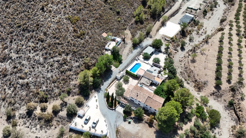 Elevated aerial view showing the complete estate, pool and surrounding rural land