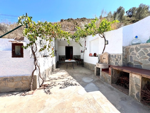 Whitewashed courtyard of the independent cave house