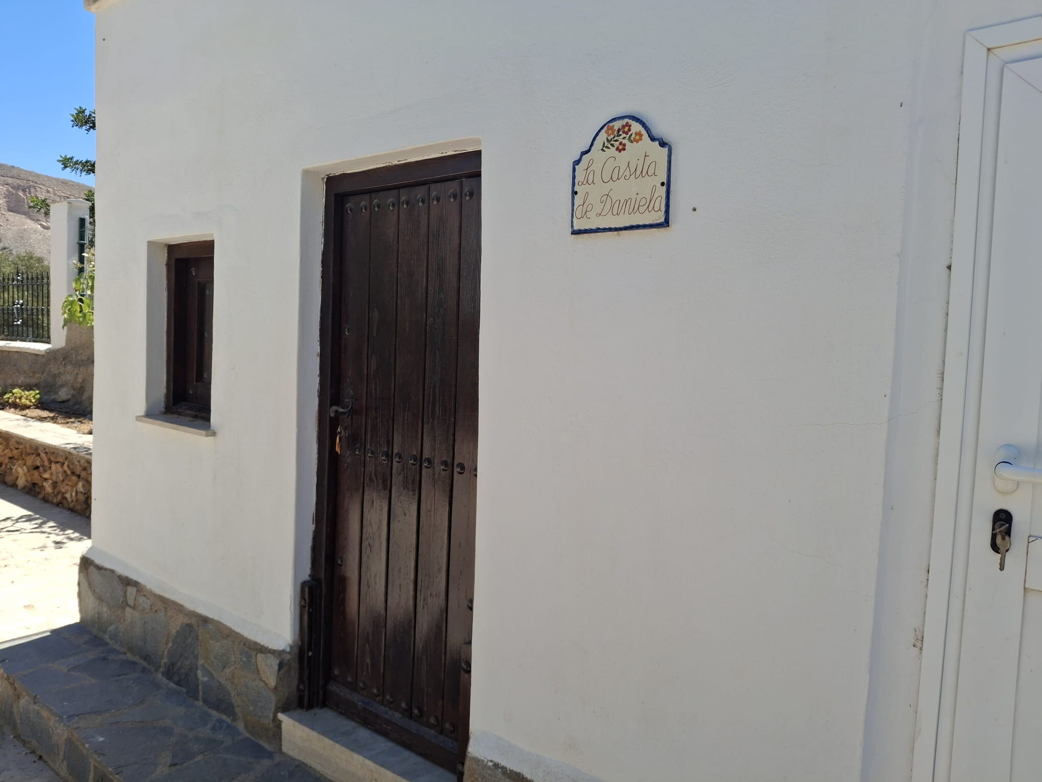 Exterior door and hand-painted sign of La Casita de Daniela