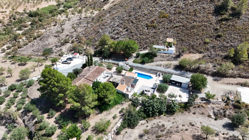 Aerial view of Cortijo del Pozo and its mountain setting