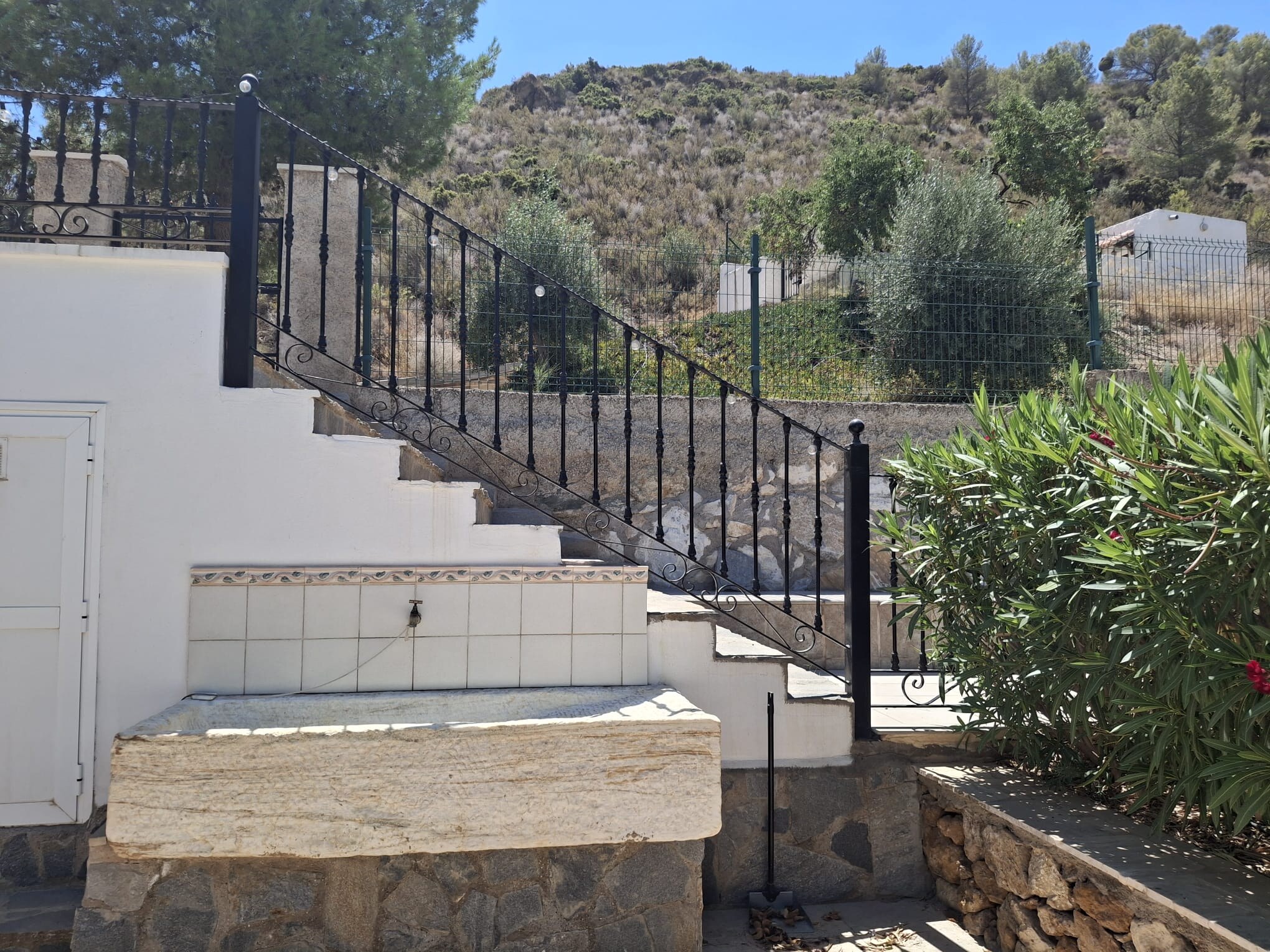 Outdoor marble bath beside the garden steps